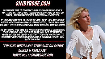 Sindy Rose Engages In Intense Anal Play With A Massive Dildo On Sandy Terrain